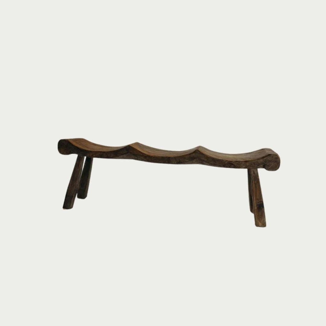 Alvarez Bench Seat in Brown suar wood, three hand-carved scooped seats on angled timber legs, shown against a plain backdrop.
