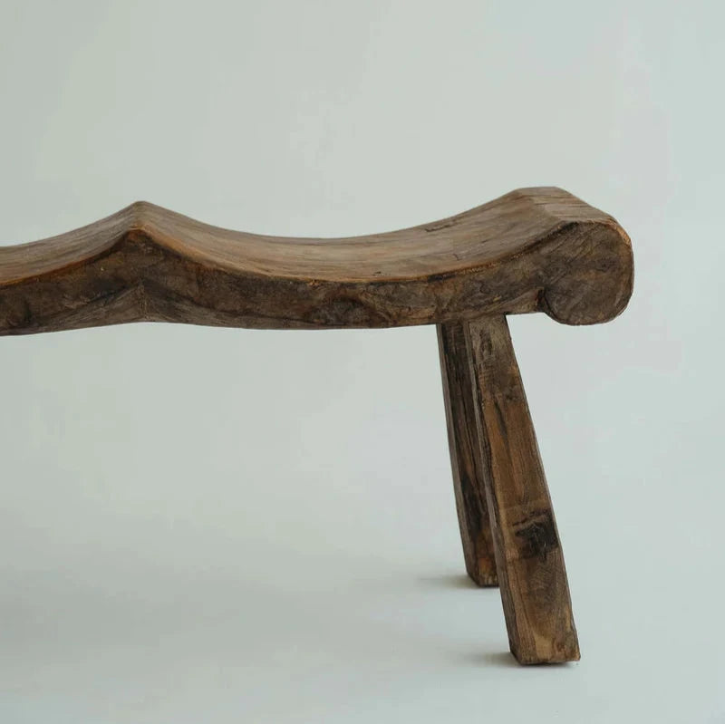 Alvarez Bench Seat in Brown suar wood, three hand-carved scooped seats on angled timber legs, shown against a plain backdrop.