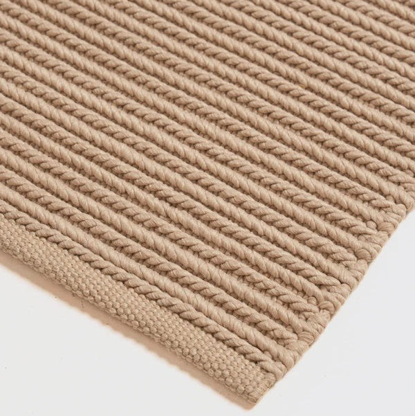 The Bay Rug, a handwoven indoor outdoor polypropylene rug with braided linear texture