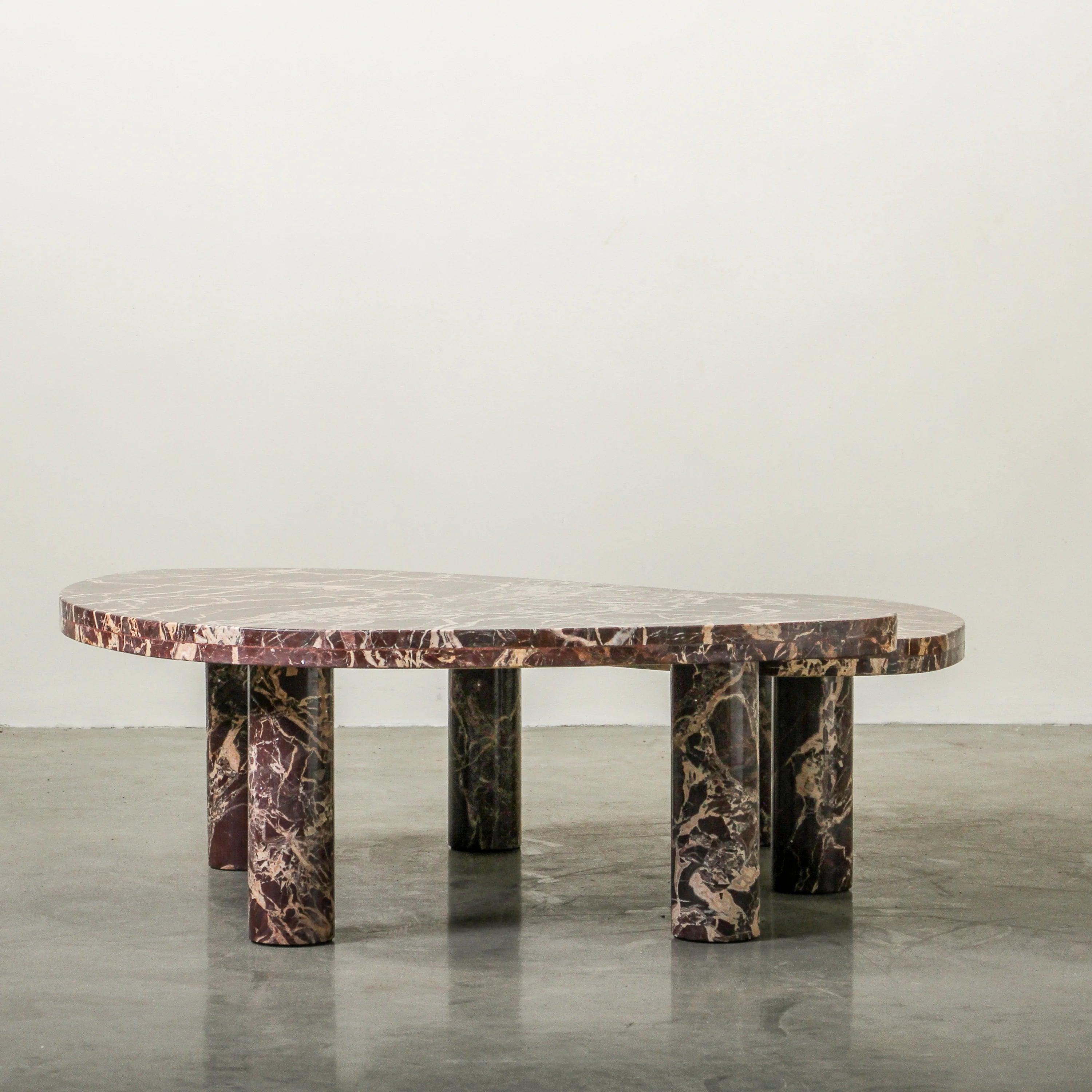 Cameo Stone Coffee Table in Cherry marble, rounded organic top on three column legs.