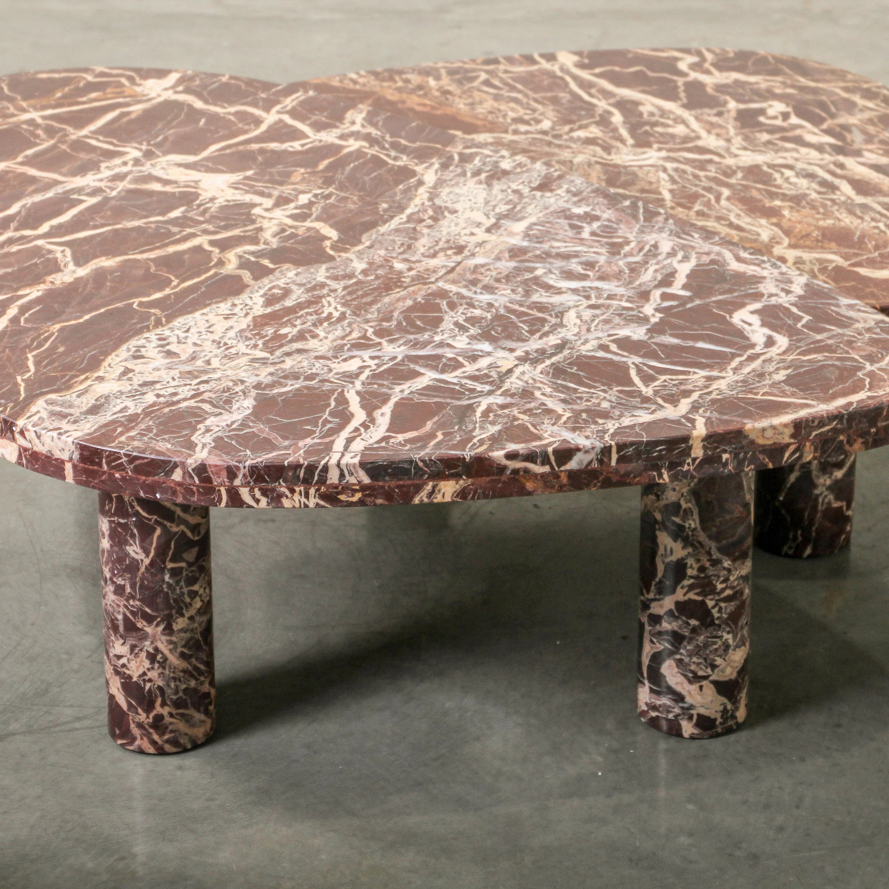 Cameo Stone Coffee Table in Cherry marble, rounded organic top on three column legs.
