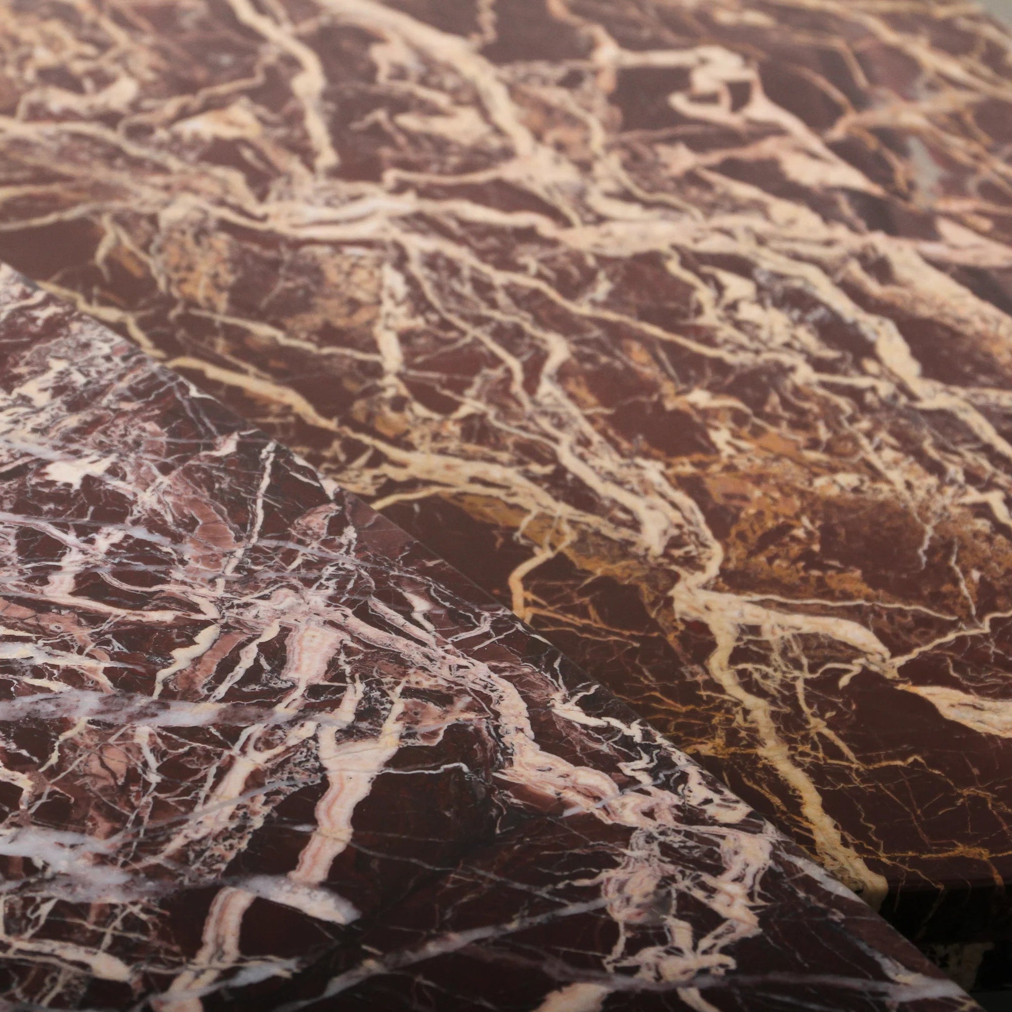 Cameo Stone Coffee Table in Cherry marble, rounded organic top on three column legs.