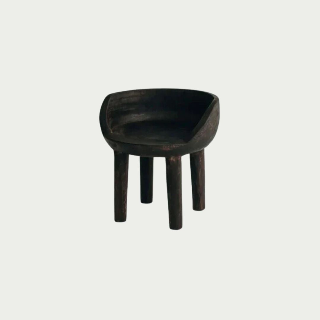 Carlos Chair in Walnut, carved rounded seat and backrest on three timber legs, shown on a white background.