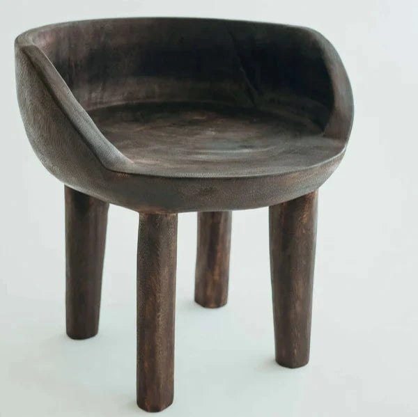 Carlos Chair in Walnut, carved rounded seat and backrest on three timber legs, shown on a white background.