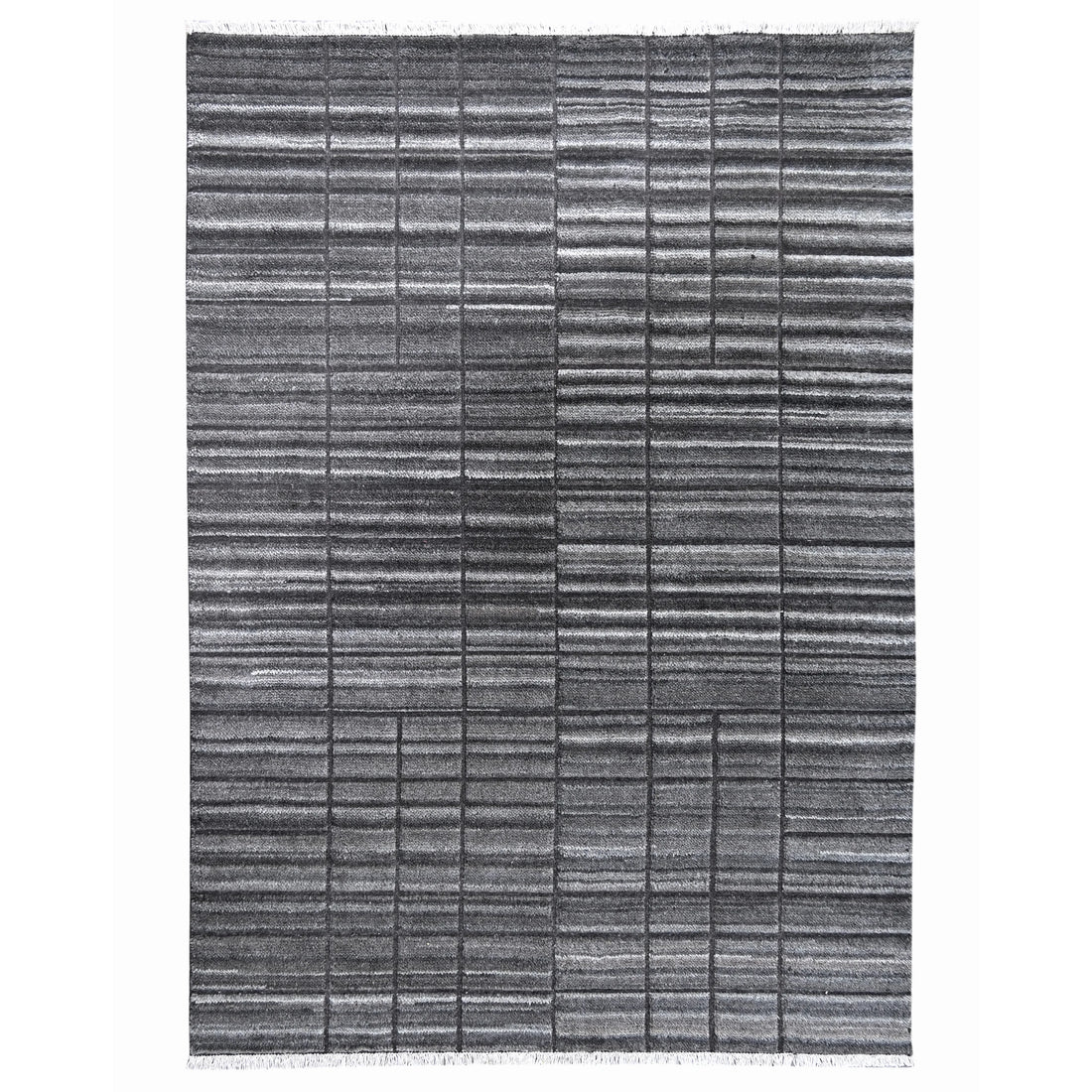 A rectangular area rug with a textured, woven horizontal stripe pattern in shades of gray and black, featuring short fringe on the top and bottom edges.