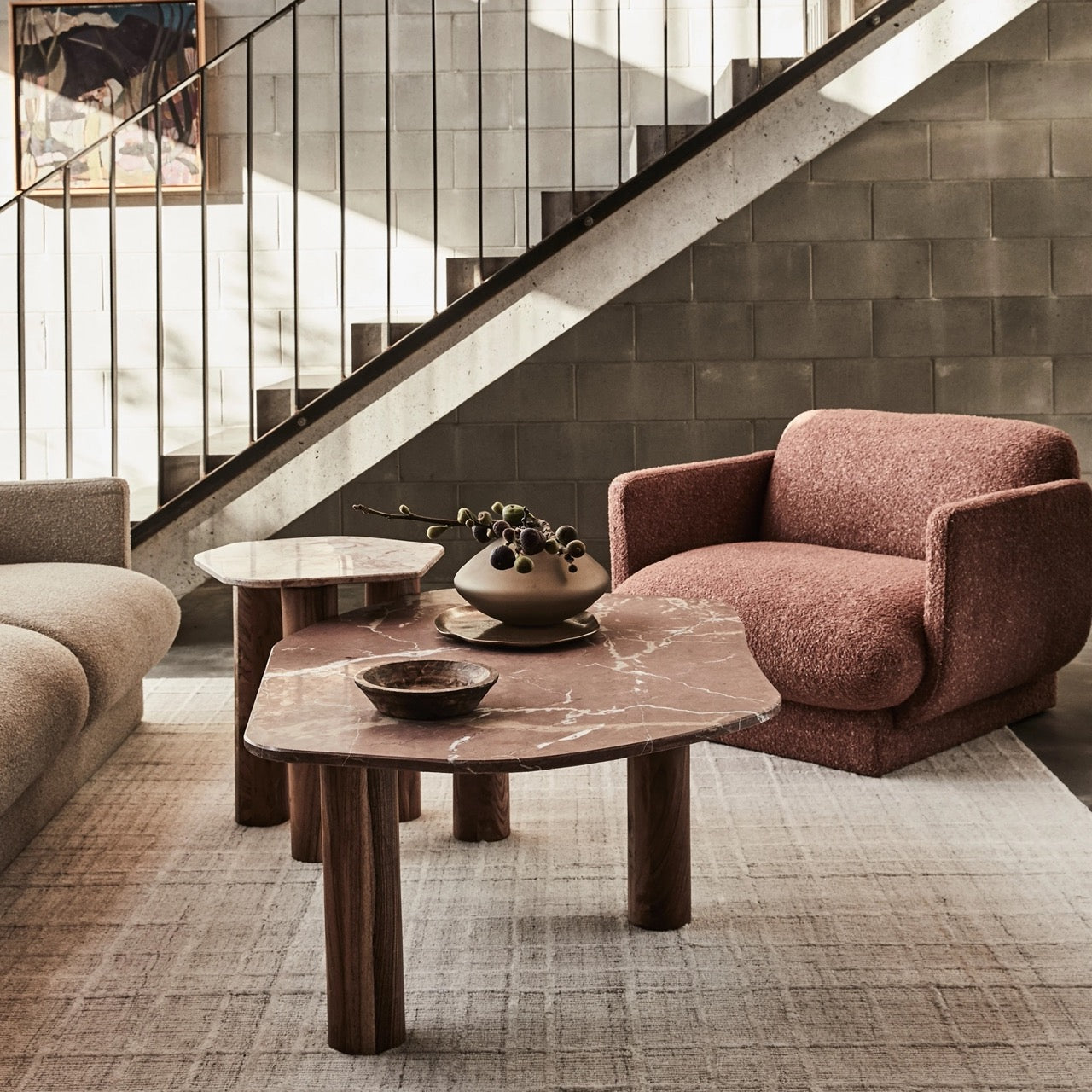 Clifton Table in Red Alicante marble, irregular rounded top on three acacia wood column legs.