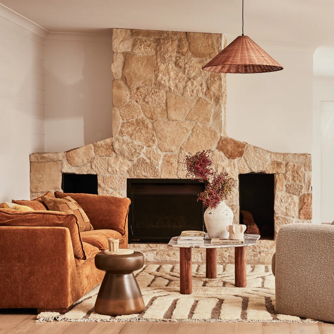 Clifton Table in Grey Lagoon marble, irregular rounded top on three acacia wood column legs.