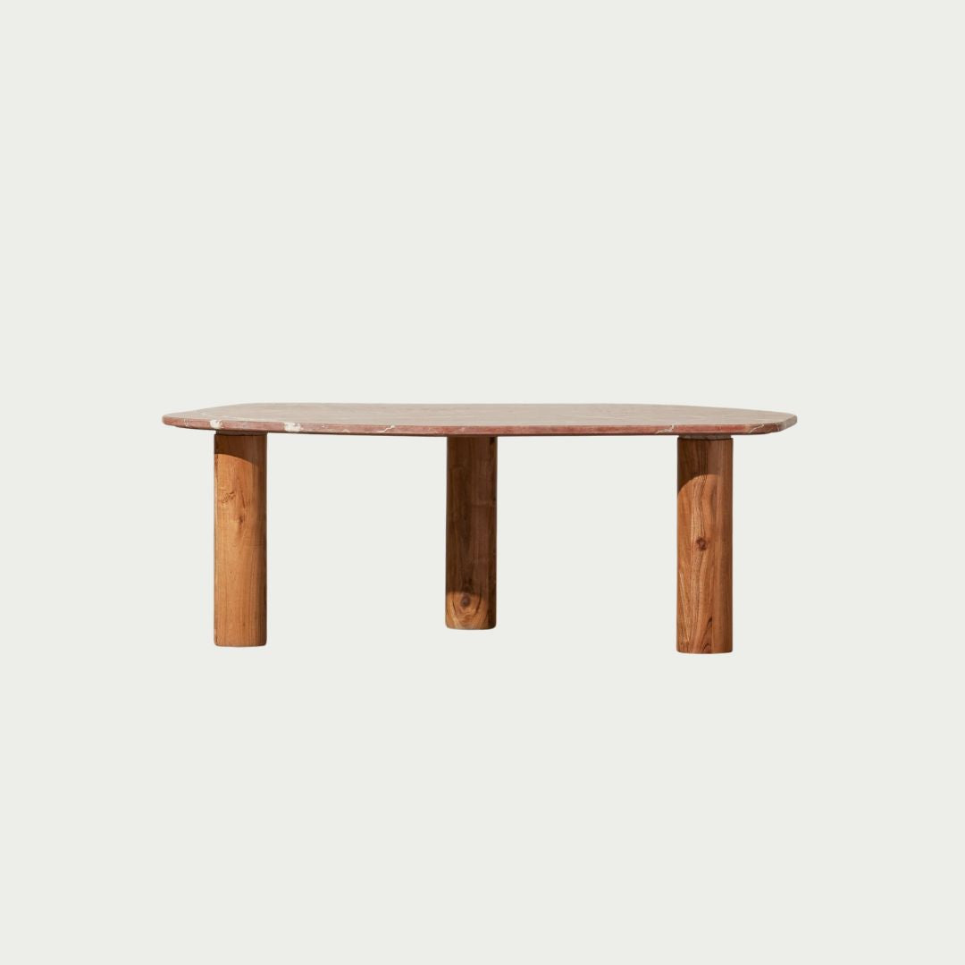 Clifton Table in Red Alicante marble, irregular rounded top on three acacia wood column legs.