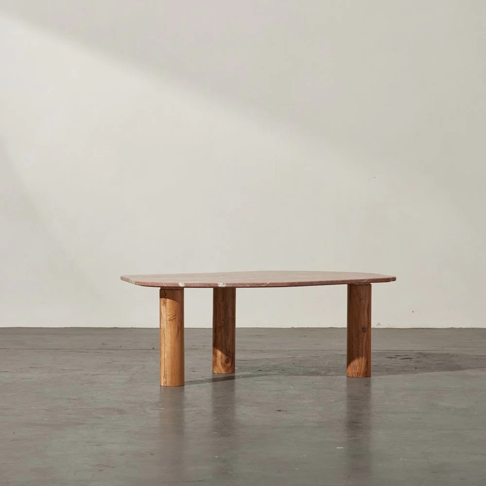 Clifton Table in Red Alicante marble, irregular rounded top on three acacia wood column legs.