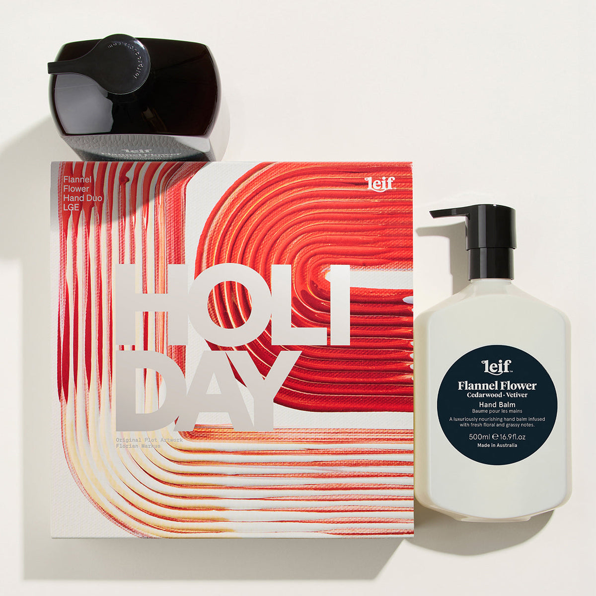 A holiday-themed gift set featuring a white bottle of telf Flamed Flower Candleboard Scented Water Bottle next to its red and white patterned packaging box, with a black telf bottle cap on top, all arranged on a clean white background.