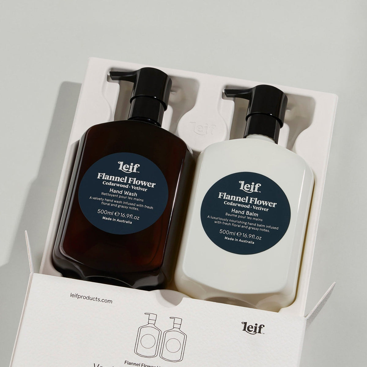 Leif Flannel Flower Hand Wash and Hand Balm gift set in a white box, featuring one dark amber bottle and one white bottle with black pumps and dark blue labels.