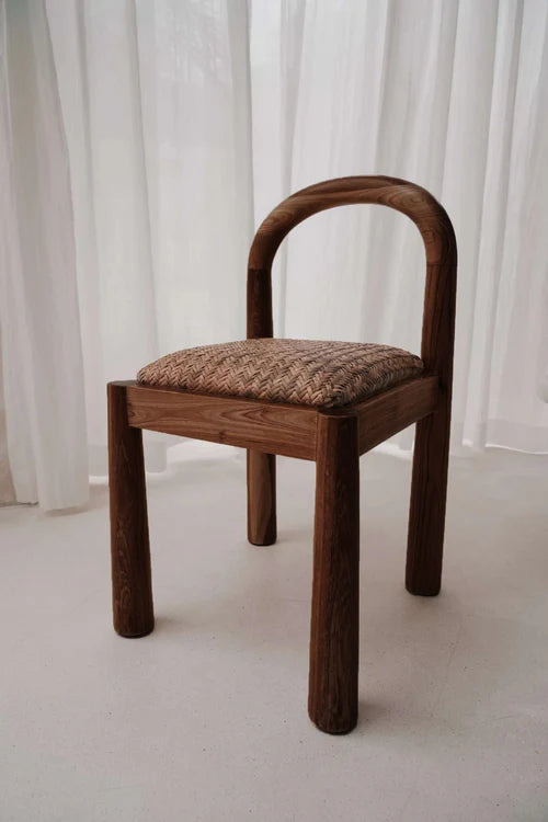 Desa Dining Chair in chocolate teak, arched backrest with hand-woven Desa pattern seat.