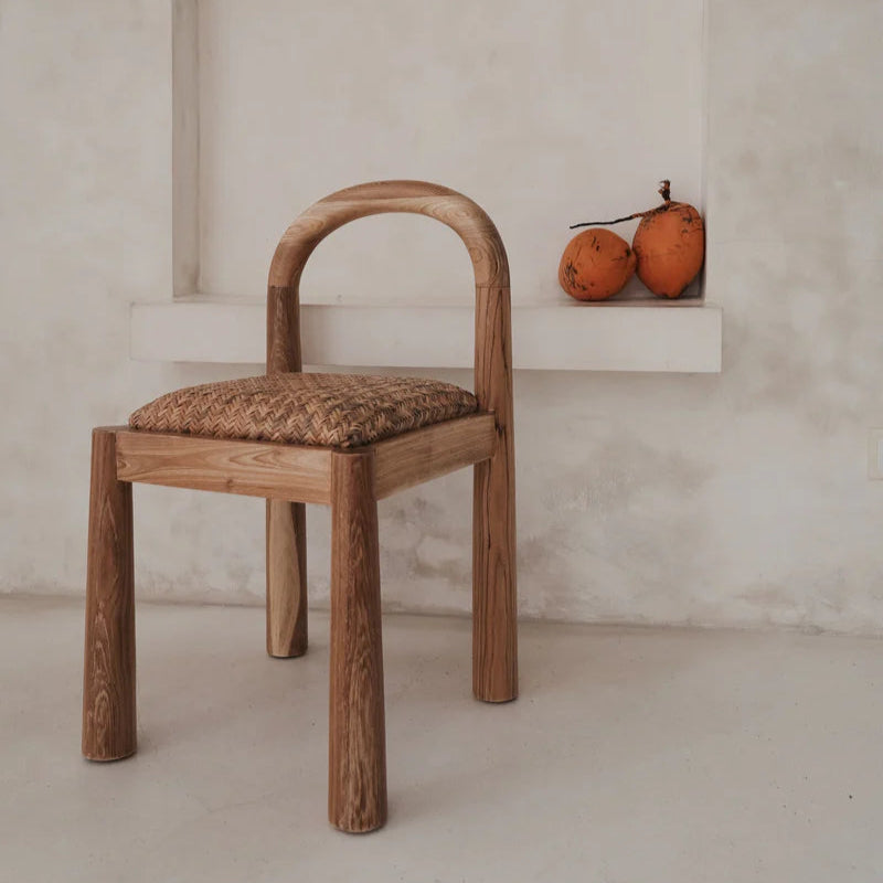 Desa Dining Chair in natural teak, arched backrest with hand-woven Desa pattern seat.