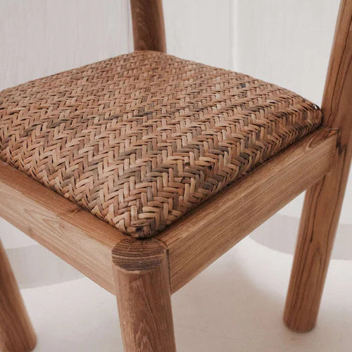 Desa Dining Chair in natural teak, arched backrest with hand-woven Desa pattern seat.