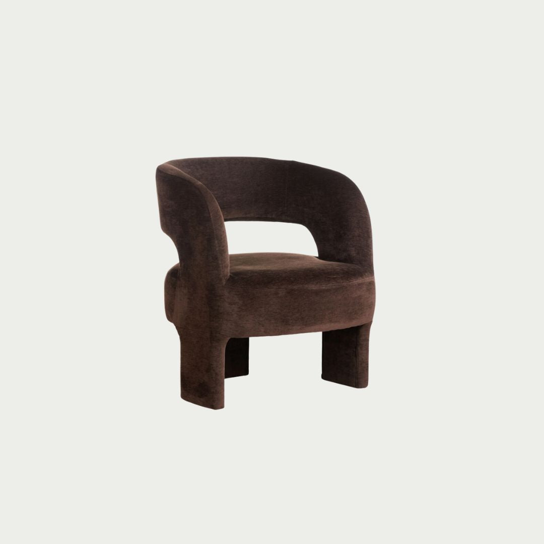 Formes Armchair in Chocolate velvet, curved cocoon backrest with an open cut-out and rounded plywood legs.