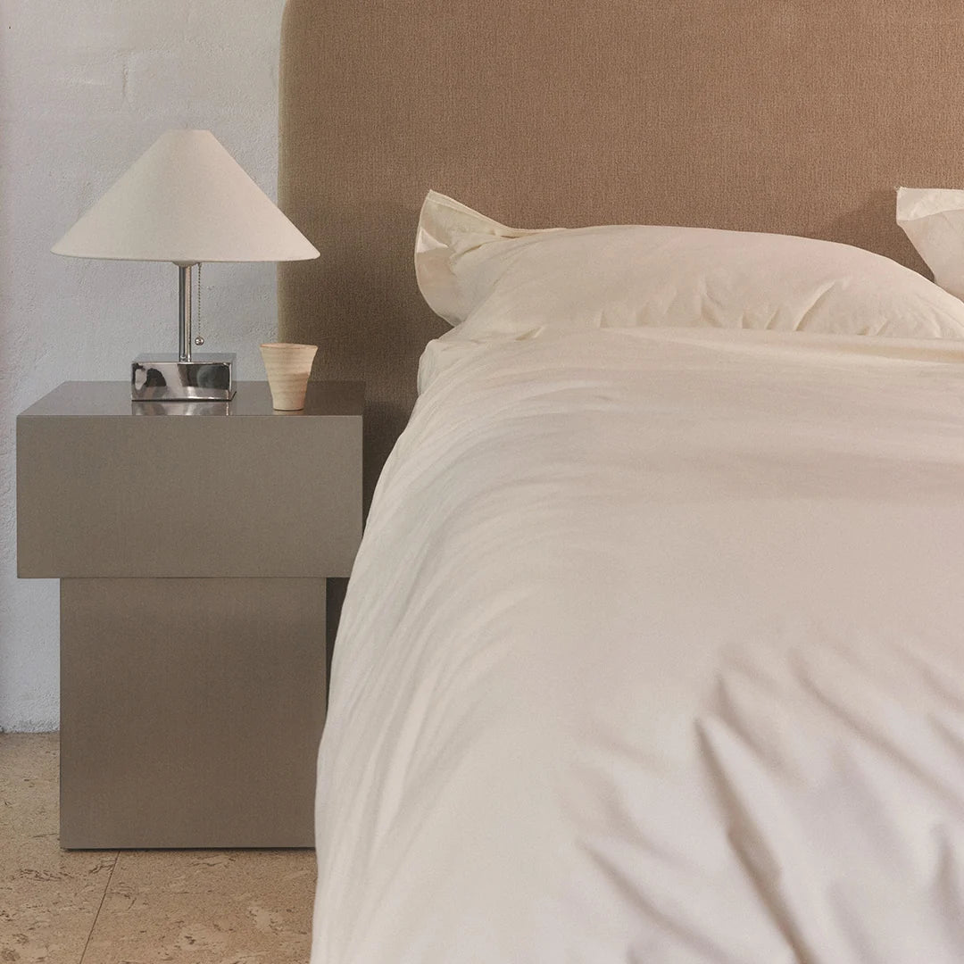 Sculptural plinth-form side table in brushed metal finish