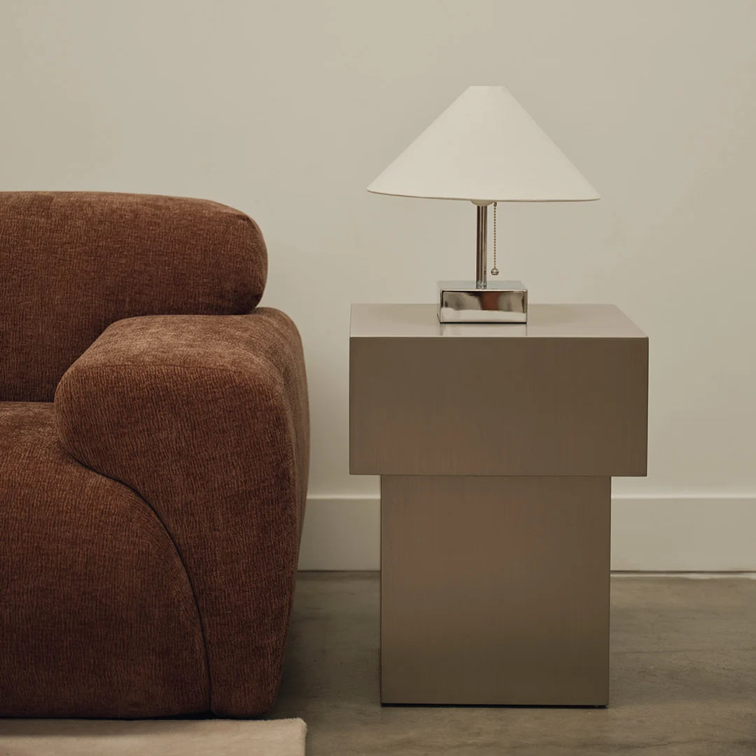 Sculptural plinth-form side table in brushed metal finish