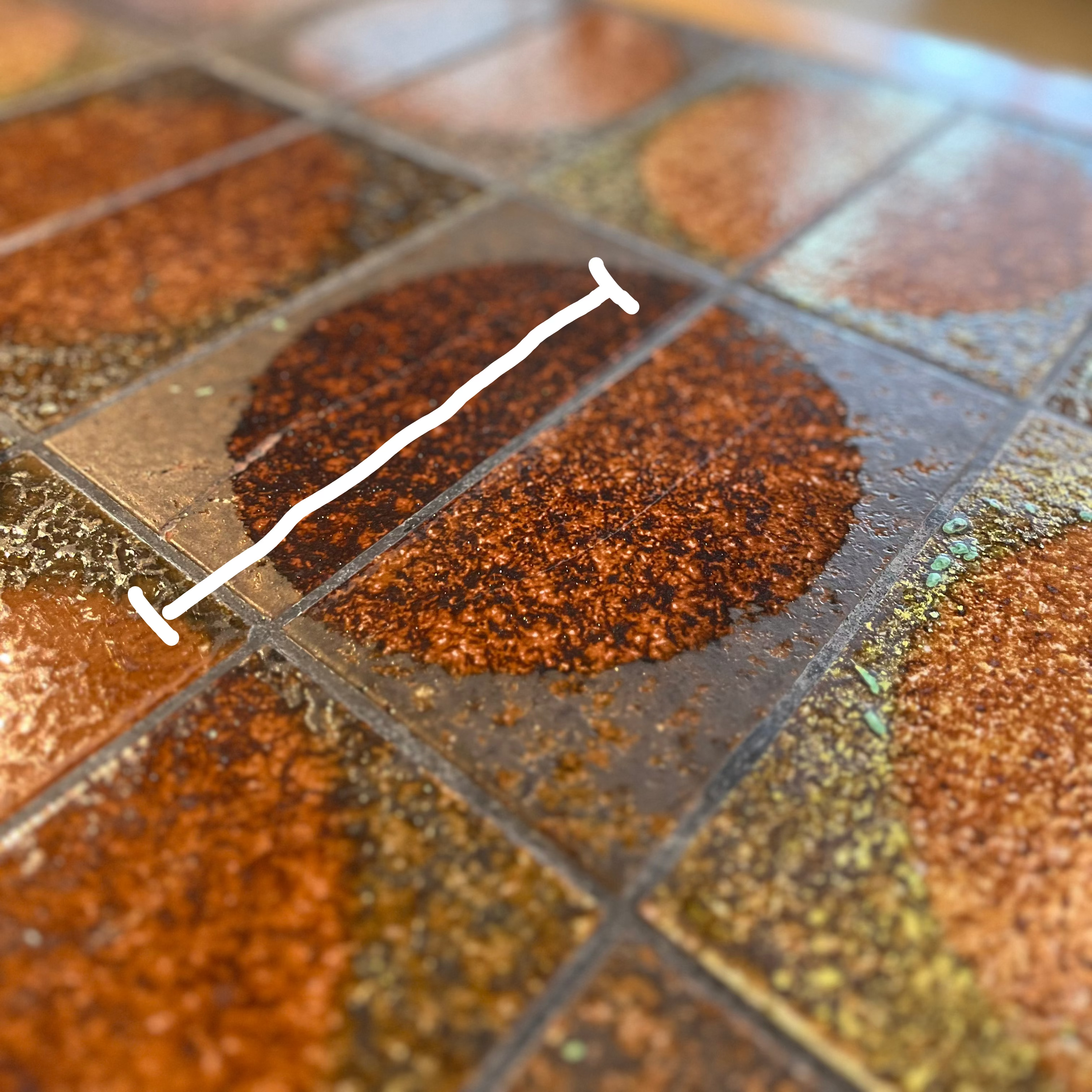 Tile coffee table Close-up of a tiled floor with brown and gray tiles