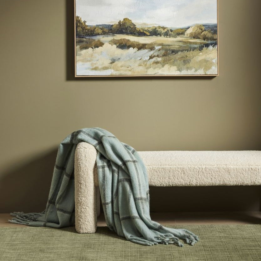 Mia Bench in off-white bouclé, rounded arm ends and chunky cylindrical legs, styled in a living room.