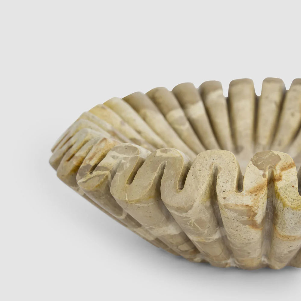 Oro Butterscotch Marble Wave Bowl, fluted carved marble with a sunburst wave pattern, shown on a white background.