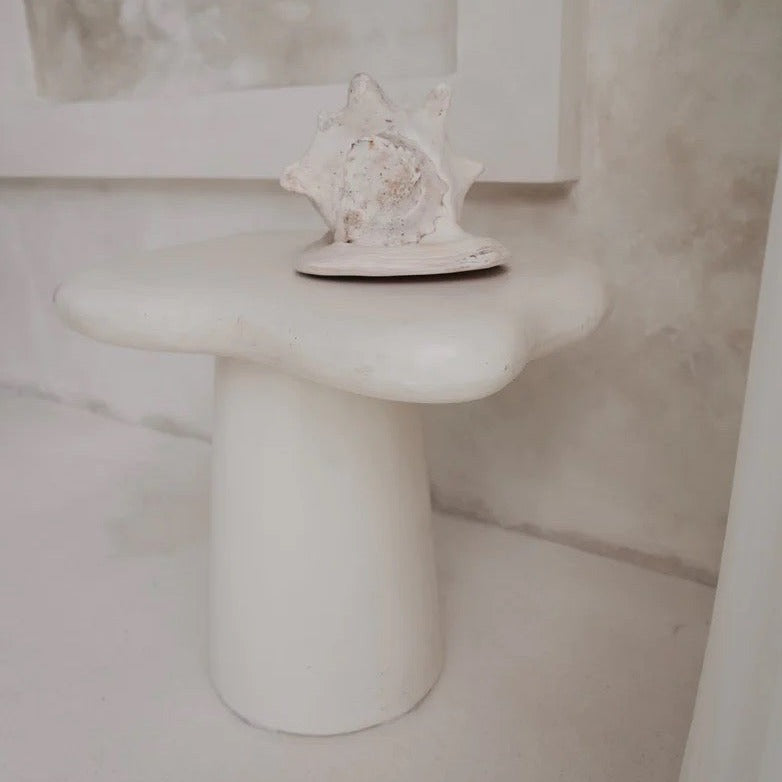 Pantai Side Table in solid concrete, organic freeform top on a tapered pedestal base.