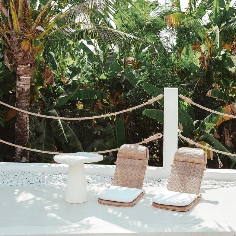 Pantai Side Table in solid concrete, organic freeform top on a tapered pedestal base.