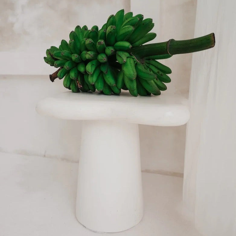 Pantai Side Table in solid concrete, organic freeform top on a tapered pedestal base.