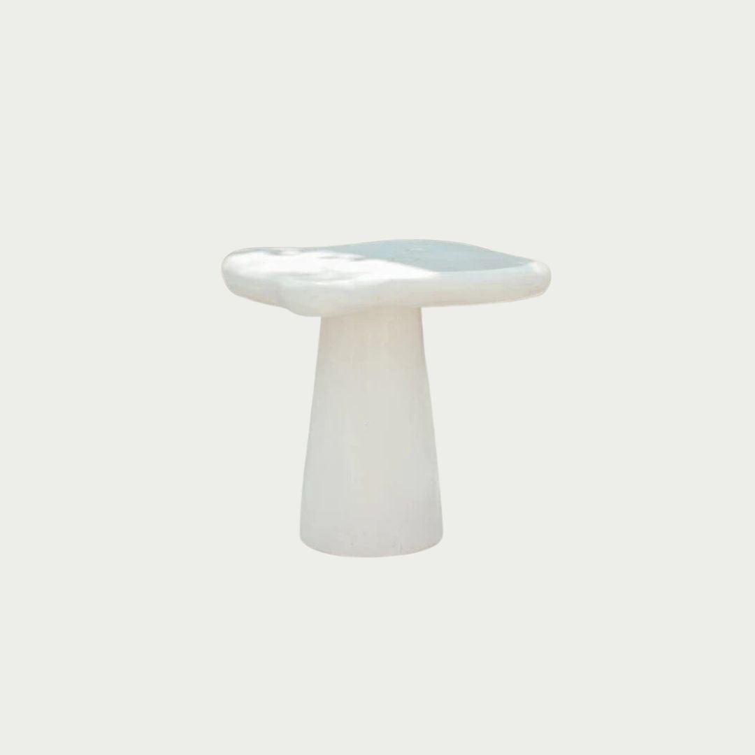 Pantai Side Table in solid concrete, organic freeform top on a tapered pedestal base, shot on a white background.