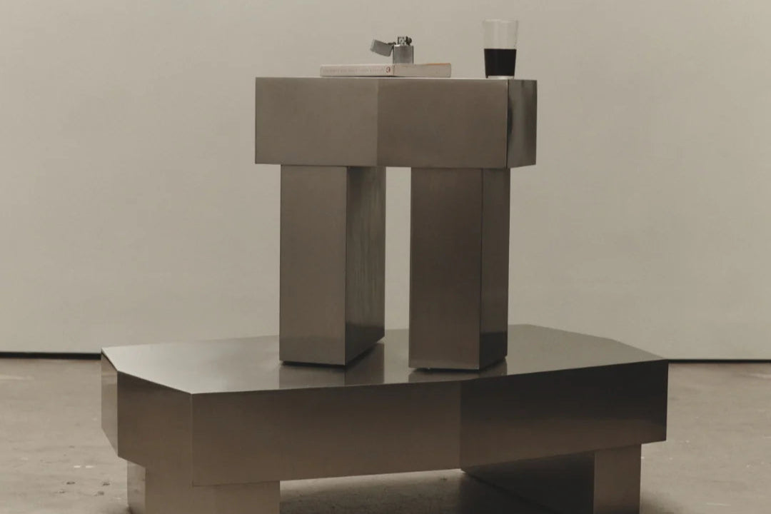 Modern brushed chrome metallic coffee table with geometric design in a minimalistic setting. Coffee table or side table. Metal look