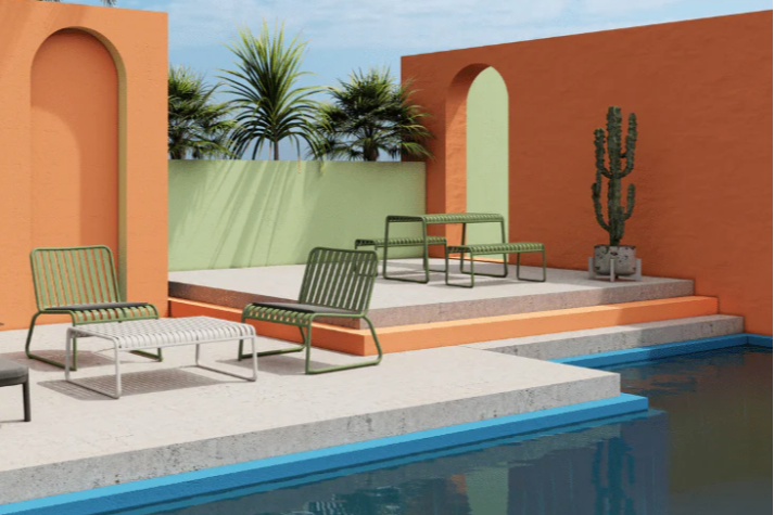 Poolside area with lounge chairs, tables, and a cactus plant against an orange wall. Alfresco seating. Banana lounges, outdoor dining, stainless steel seating, powdercoated seating. 