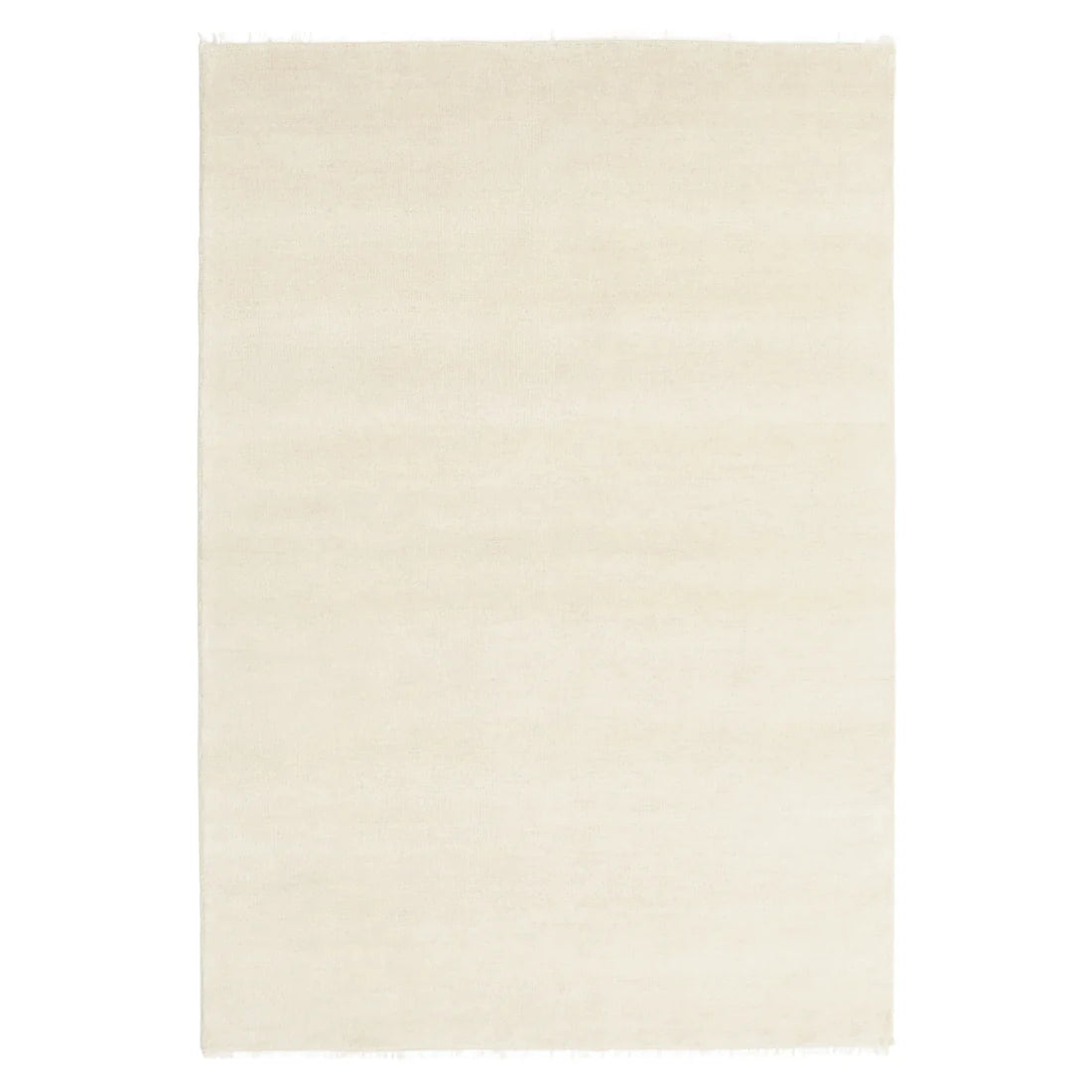 A rectangular cream-colored area rug with a soft, textured surface and subtle fringed edges, shown flat against a white background.