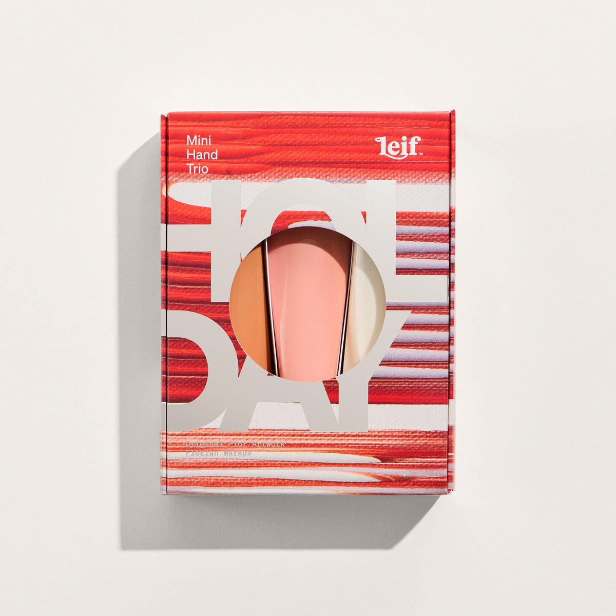 Leif Mini Hand Nail Kit in its red and white patterned packaging, showing a peach-pink nail polish bottle inside a circular cutout, on a light beige background.