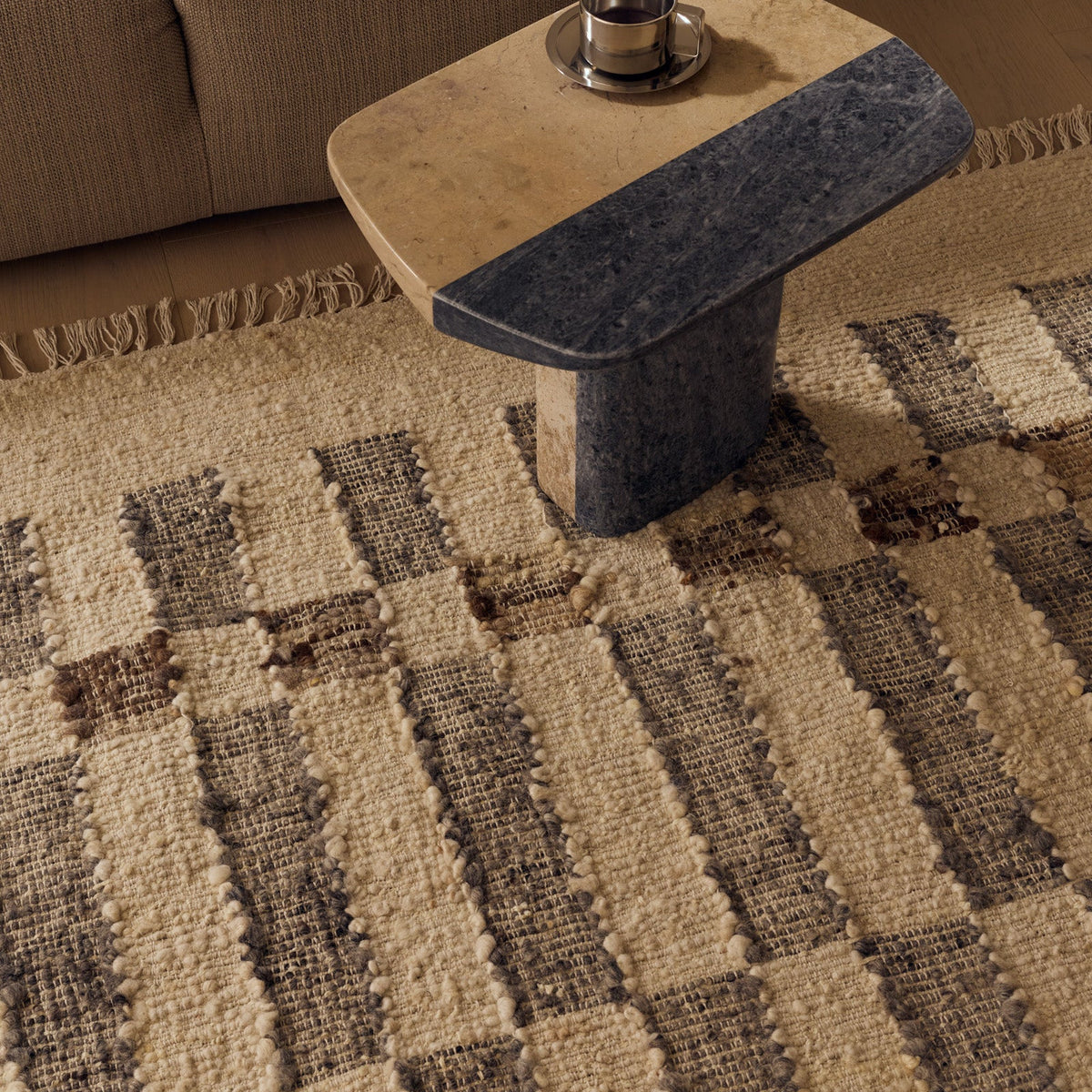Tribe Home Chet Rug in sandstone wool and jute with an offset misty grey chequered block pattern, brown accents and fringed ends