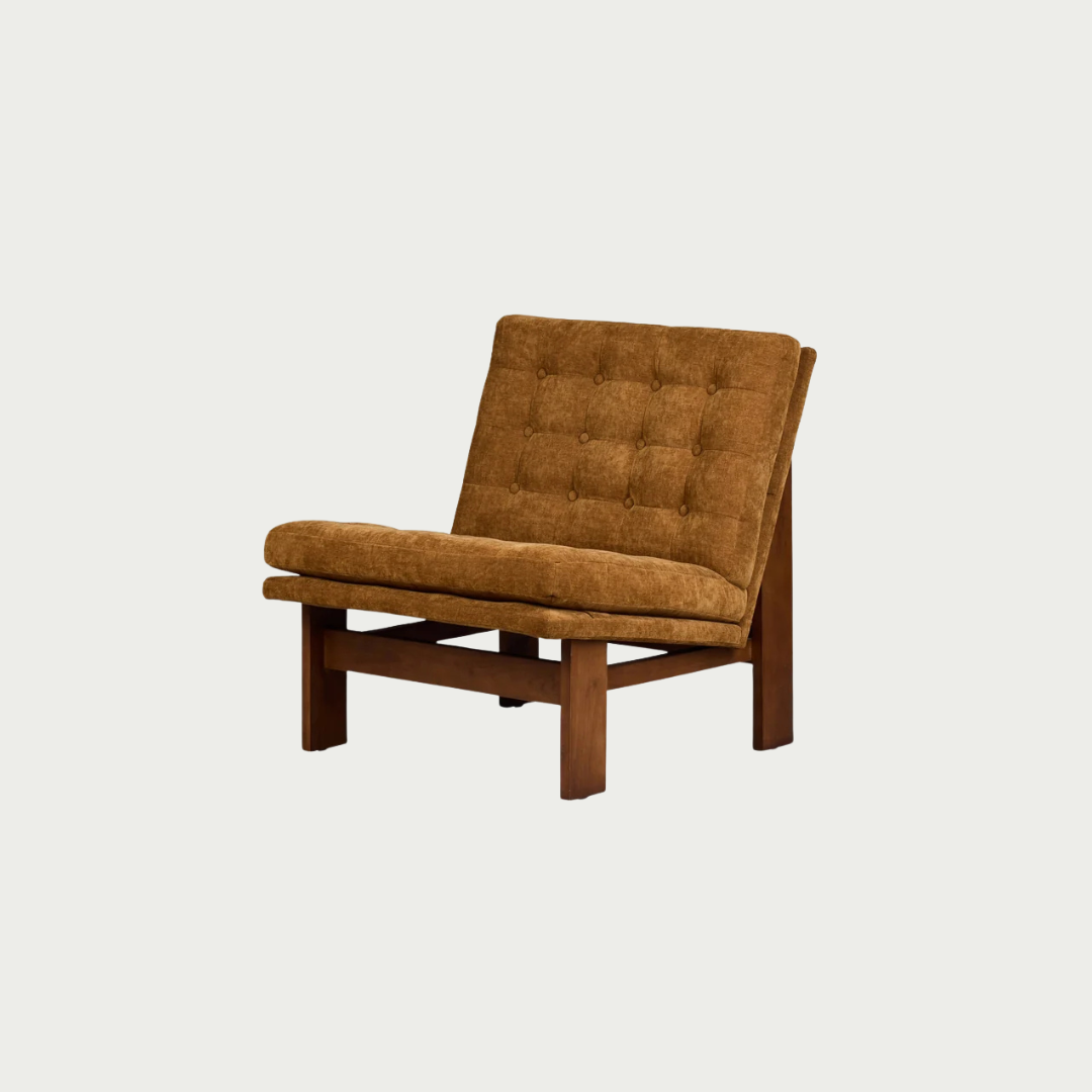 A mid-century modern accent chair with a tufted mustard brown velvet seat and backrest, supported by a dark brown wooden frame, shown against a solid off-white background.