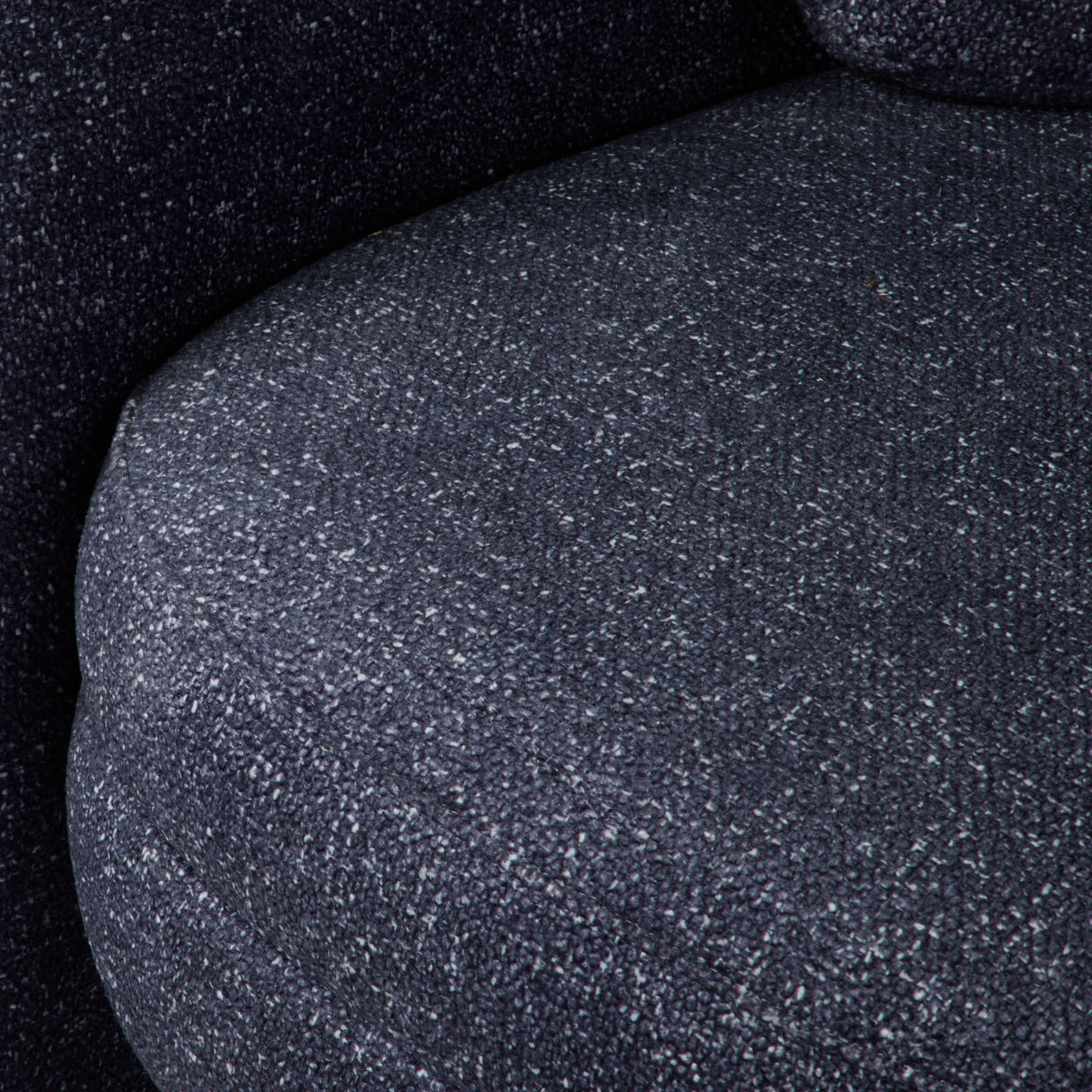 Walter Armchair in Navy, chunky bouclé fabric with rounded arms and an open base.