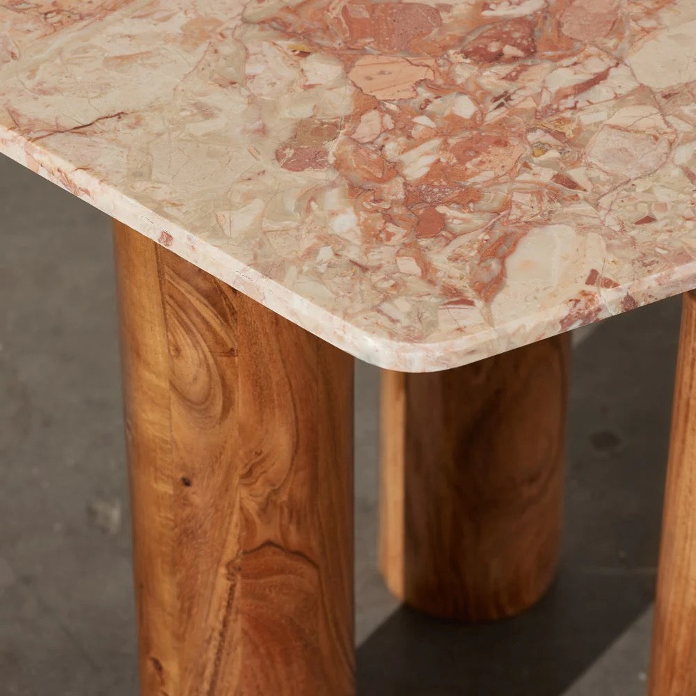Waverly Side Table in Pink Lagoon marble, irregular rounded top on three wooden column legs.