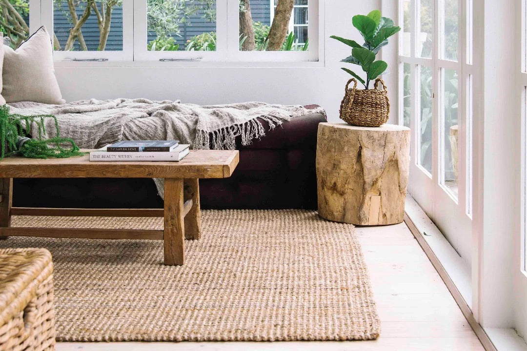 Cozy living room with wooden coffee table, sofa, and natural decor. Jute floor rug, hallway runner, natural jute