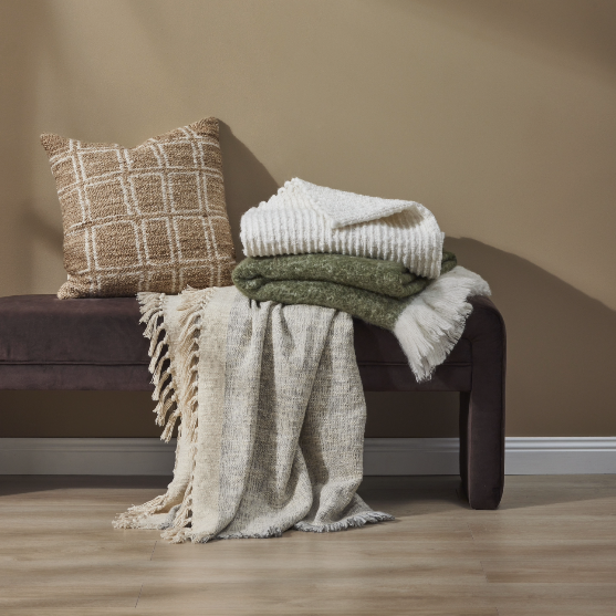 Zaha Bench Seat in Chocolate velvet, rounded arm ends and curved plywood legs, styled with cushions and throws.