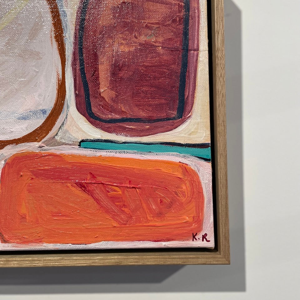 Abstract framed painting with geometric shapes in terracotta, orange, cream, and teal, shown hanging on a light gray wall.