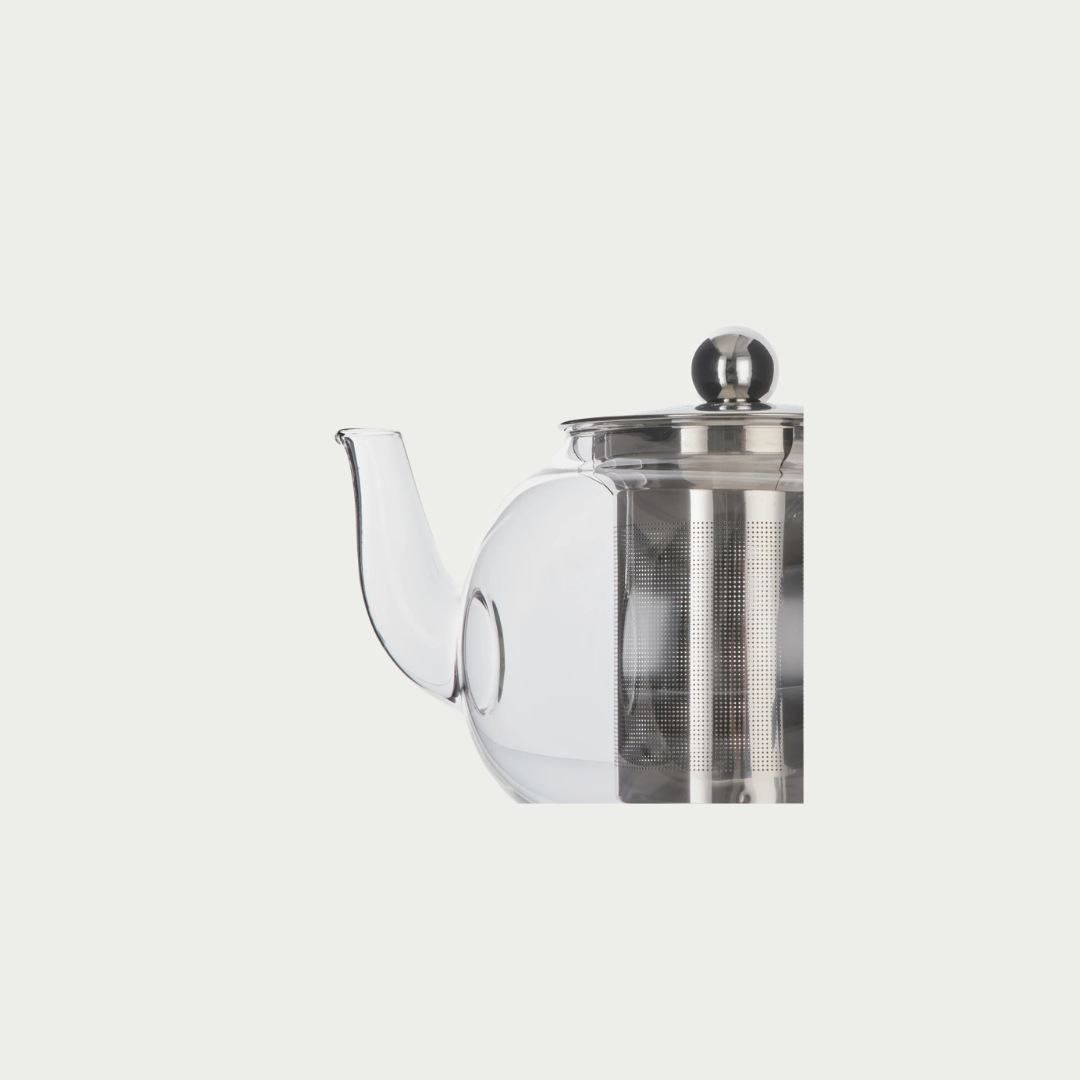 A clear glass teapot with a stainless steel inner chamber and lid, shown against a solid light gray background.