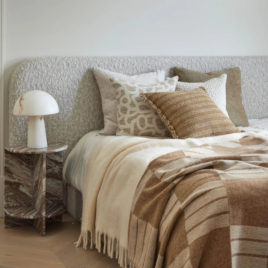 Cozy bedroom with a bed featuring marble bedside table 