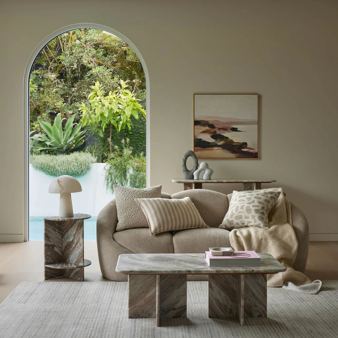 Modern living room with a beige sofa, marble side table and coffee table