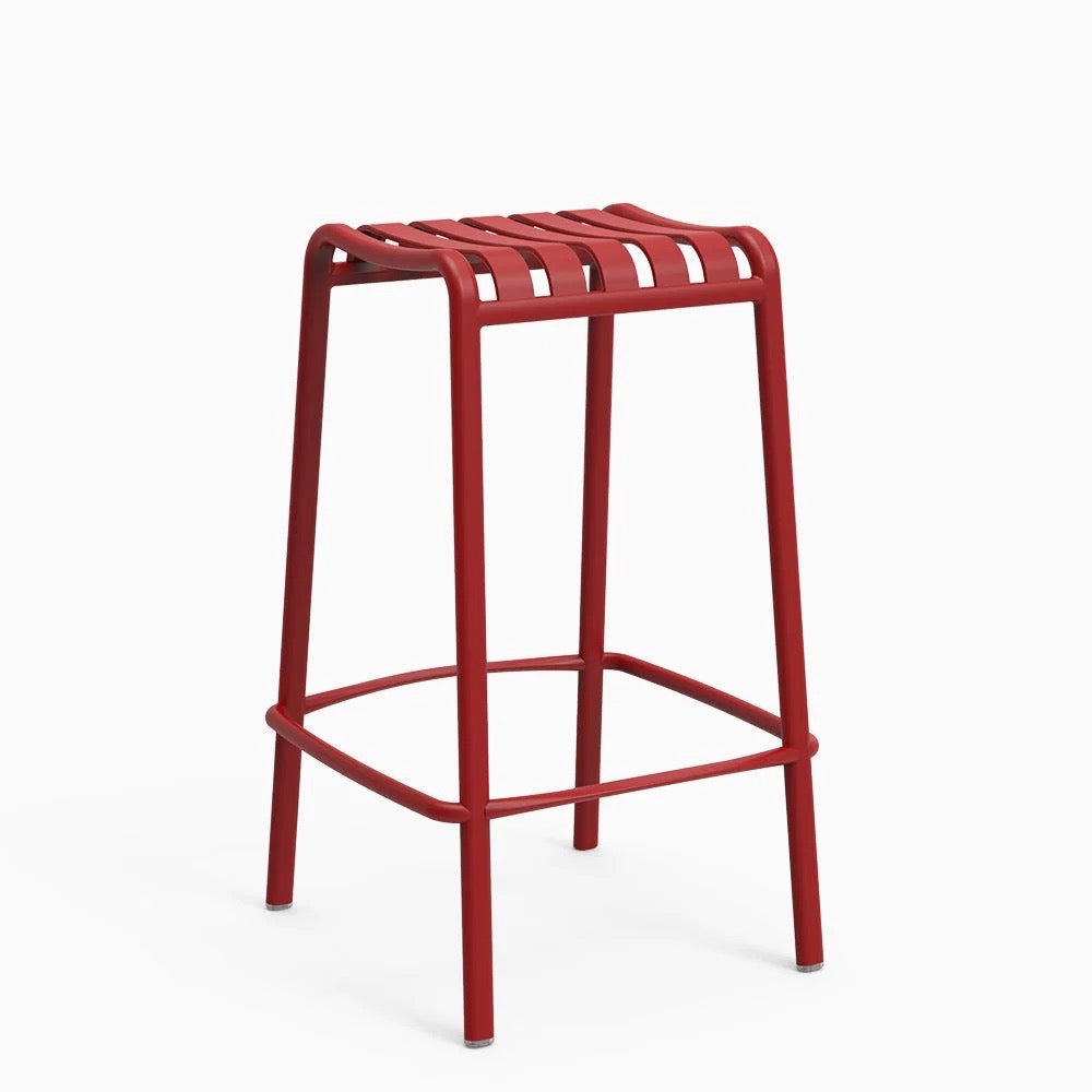 A red backless stool with a lightweight aluminum frame and a natural textured finish.