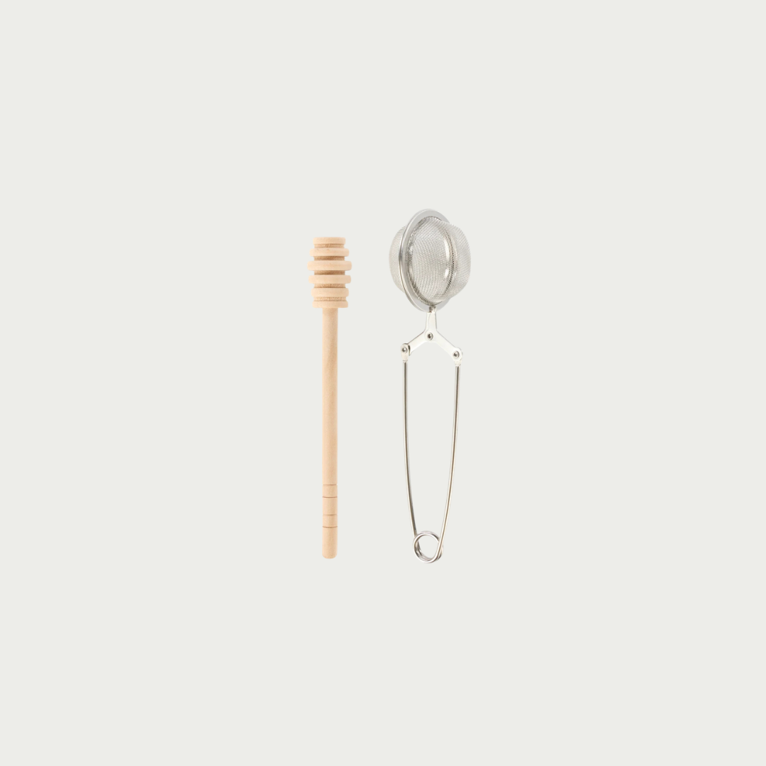A wooden honey dipper with a slotted bowl and a small metal tea infuser strainer, both shown against a solid light gray background.