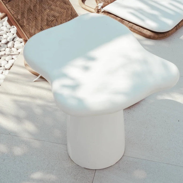 Pantai Side Table in solid concrete, organic freeform top on a tapered pedestal base.